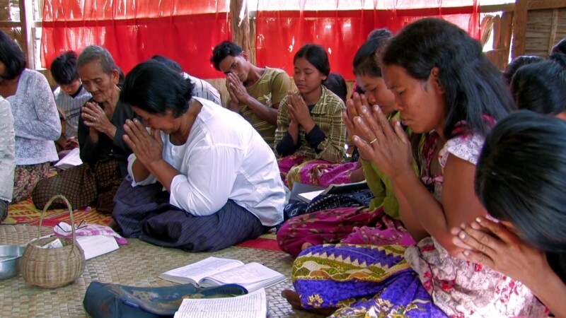 Prayer in a Bamboo Church — Christians pray at a temporary church in CambodiaKeywords: Christian, church, religion, world religion, prayer, praying