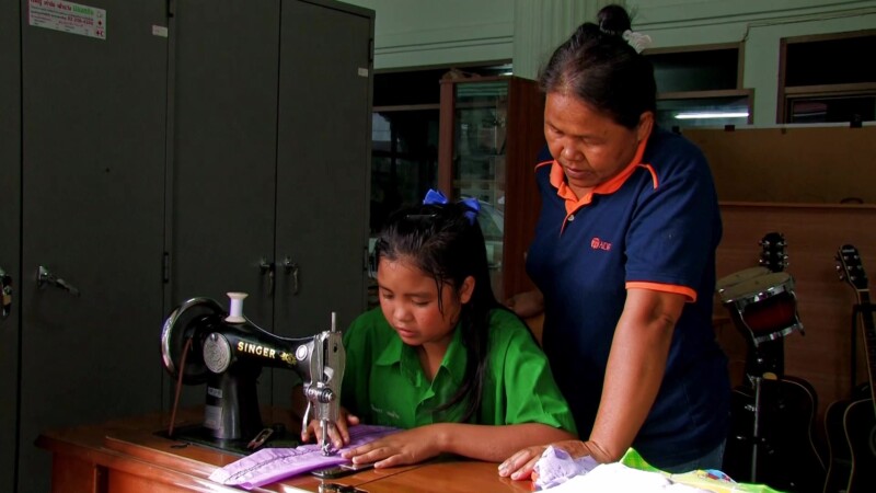 Learning to Sew — Young girl, living in a shelter for her protection, learns a marketable skill by learning how to sew. — girl, livelihood, skills training, ...