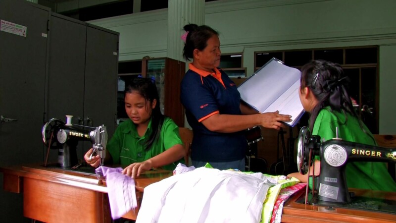 Learning to Sew — Young girl, living in a shelter for her protection, learns a marketable skill by learning how to sew. — girl, livelihood, skills training, ...
