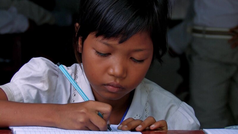 Student in Cambodia — Girls at her desk at a school in Phnom Penh, CambodiaKeywords: Education, girl, school, writing, Cambodia