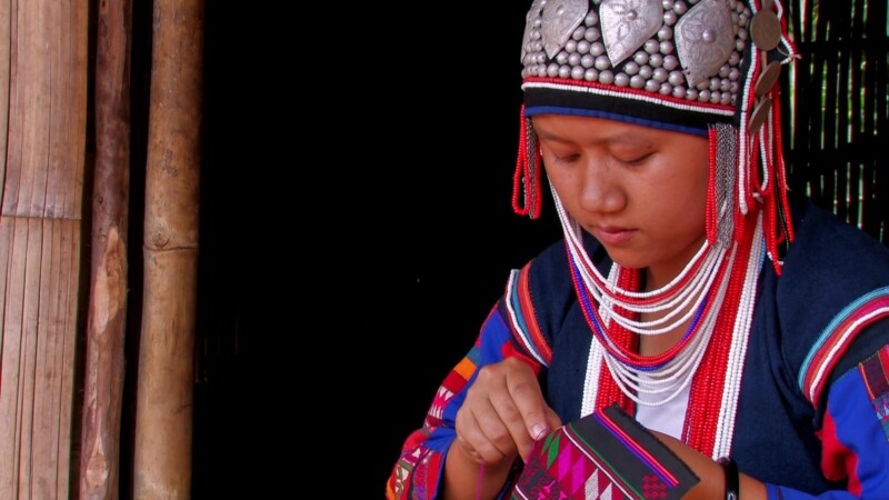 Ethnic Girl in Thailand — A girl from an Ethnic minority in Thailand does traditional embroidery in the doorway of her bamboo home. — Girl, thailand, Ethnic,...