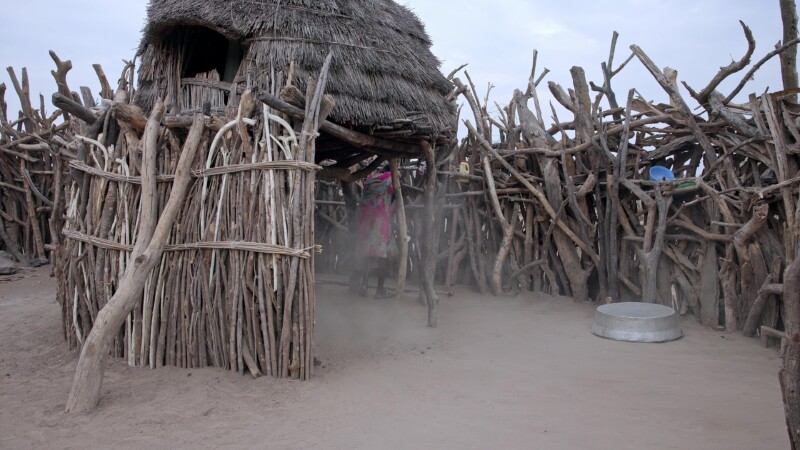 Sweeping the Compound — Young African girl sweeps the family compound as an early morning choreKeywords: Africa, South Sudan, Rural, Remote, Pastoralists, Ea...