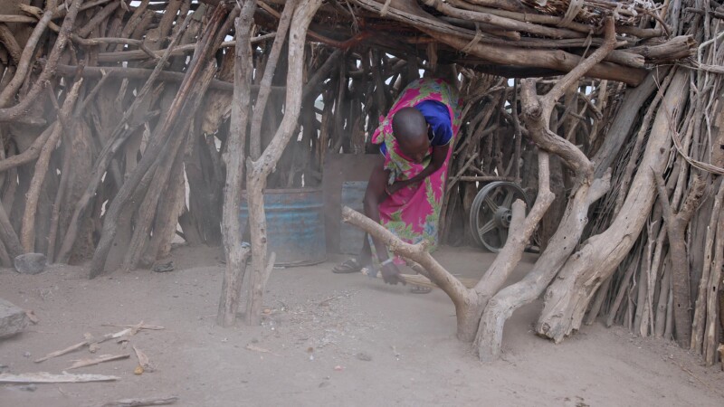 Sweeping the Compound — Young African girl sweeps the family compound as an early morning choreKeywords: Africa, South Sudan, Rural, Remote, Pastoralists, Ea...