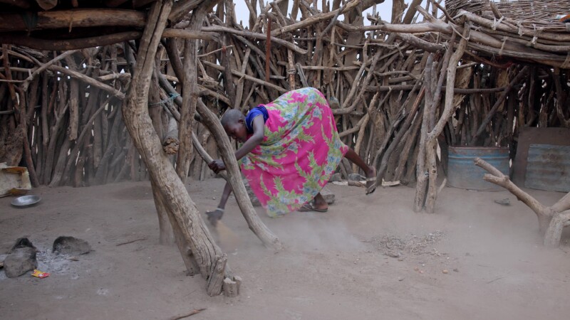 Sweeping the Compound — Young African girl sweeps the family compound as an early morning choreKeywords: Africa, South Sudan, Rural, Remote, Pastoralists, Ea...