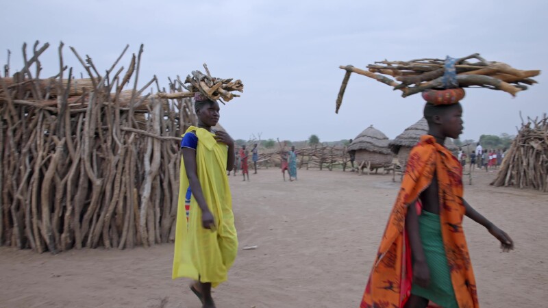 Walking with Firewood — Young African girls walk with firewood on their head as they return home to cook breakfast. — Africa, South Sudan, Rural, Remote, Pas...
