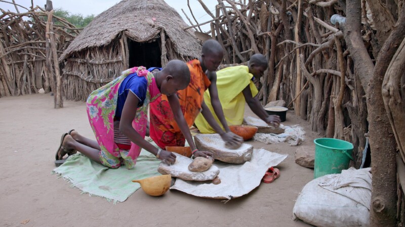Grinding Flour — Girls in South Sudan grind grain into flour for cooking, using traditional grinding stones. — Africa, South Sudan, Rural, Remote, Pastoralists