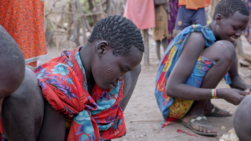 Shelling Fruit — Children in Africa pound a hard-shelled wild fruit that grows on bushes outside their village in South Sudan. — Africa, South Sudan, Rural, ...