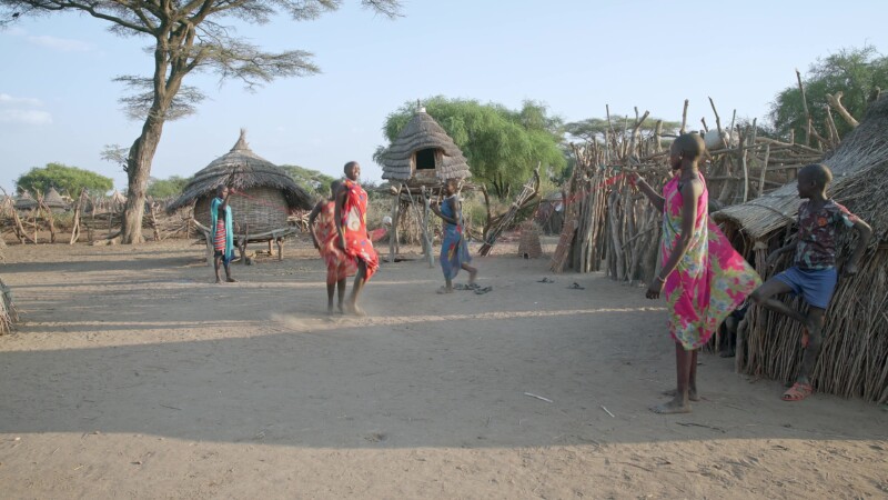 Skipping in Africa — Girls in Africa skip in the evening light. — Africa, South Sudan, Rural, Remote, Pastoralists