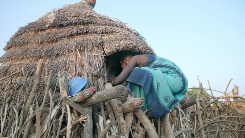 Elevated Bedroom for Girls — Young girls in Africa demonstrate the difficulty of getting in and out of the elevated room where they sleep — Africa, South Sud...