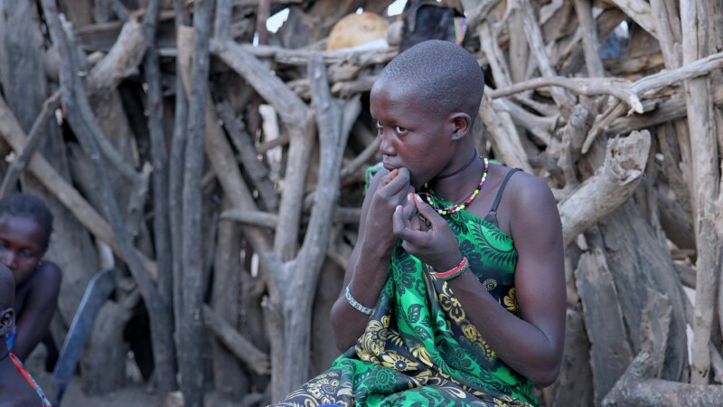 Making Beads — Girls works on making a bead necklace. — Africa, South Sudan, Rural, Remote, Pastoralists