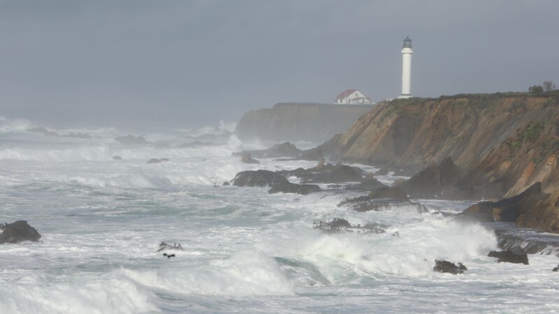 Lighthouse on the Westcoast — Waves roll in with a lighthouse in the backgroundKeywords: United States, Scenic, Oregon, Coast, beach, sea, Ocean