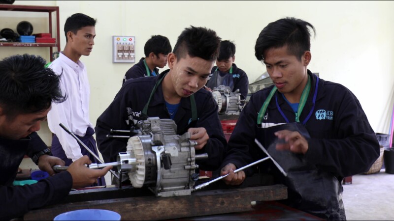 Small Engine Repair — Young men in Myanmar learn how to repair the small engines that farmers use to plow their fieldsKeywords: Myanmar, Burma, Burmese, Kare...