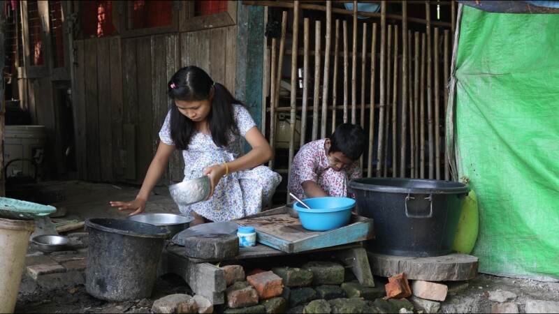 Cooking Food — A young girl in Myanmar cooks dinner for her family in an open kitchen outside her home. — Myanmar, Burma, Burmese, Karen, cooking