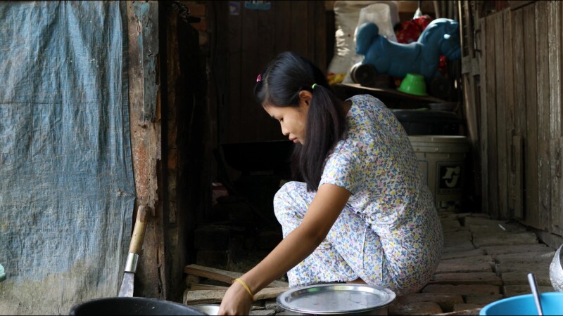 Cooking Food — A young girl in Myanmar cooks dinner for her family in an open kitchen outside her home. — Myanmar, Burma, Burmese, Karen, cooking