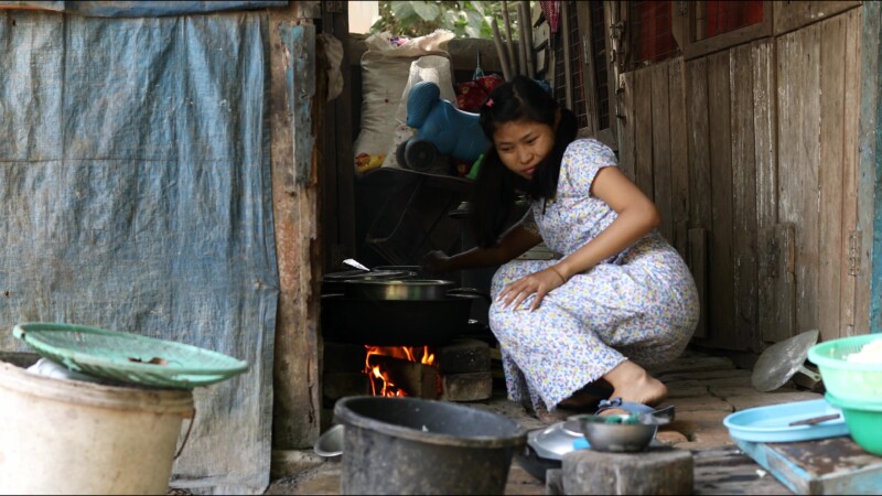 Cooking Food — A young girl in Myanmar cooks dinner for her family in an open kitchen outside her home. — Myanmar, Burma, Burmese, Karen, cooking