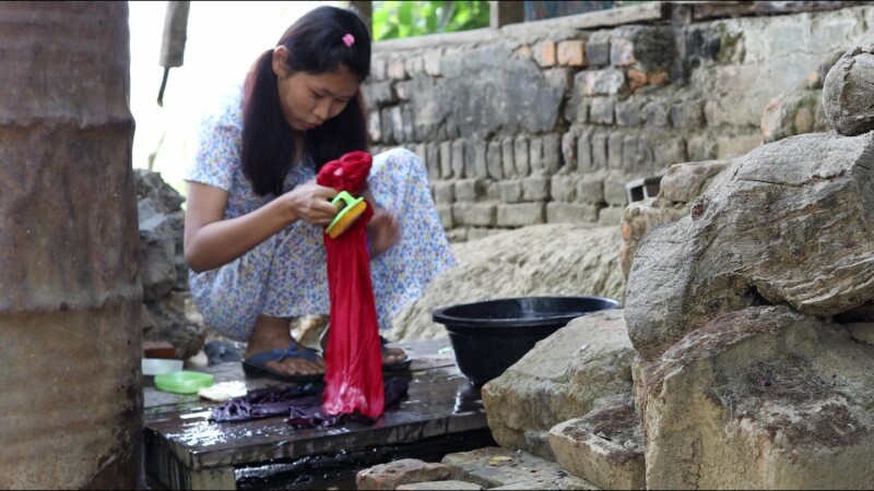 Washing Clothes — Young woman in Myanmar washes clothes for her family. — Myanmar, Burma, Burmese, Karen, washing clothes