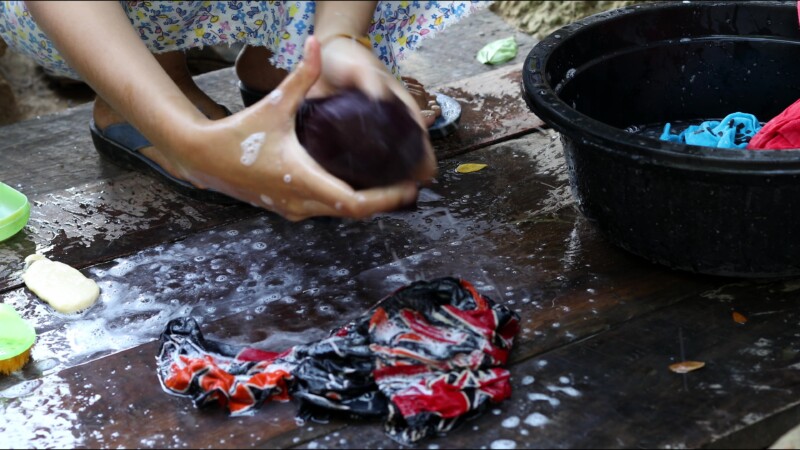 Washing Clothes — Young woman in Myanmar washes clothes for her family. — Myanmar, Burma, Burmese, Karen, washing clothes