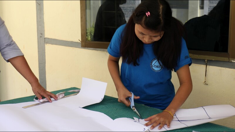 Attending a Trade school — Young hearing impaired girl goes to a trade school each day to learn how to make clothes so she can start her own income generatin...
