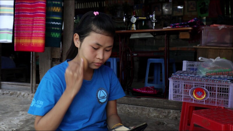 Putting on Thanaka — Young woman in Myanmar puts on thanaka, a skin cream made from the wood of the thanaka tree — Myanmar, Burma, Burmese, Karen, thanaka