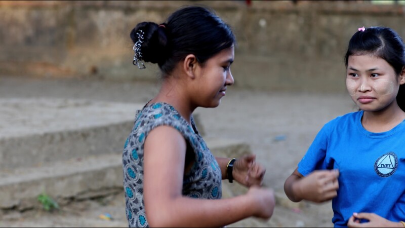 Hearing Impaired Woman Talks with her Hands — A young woman in Myanmar talks with her sister using sign language. — Myanmar, Burma, Burmese, Karen, sign lang...